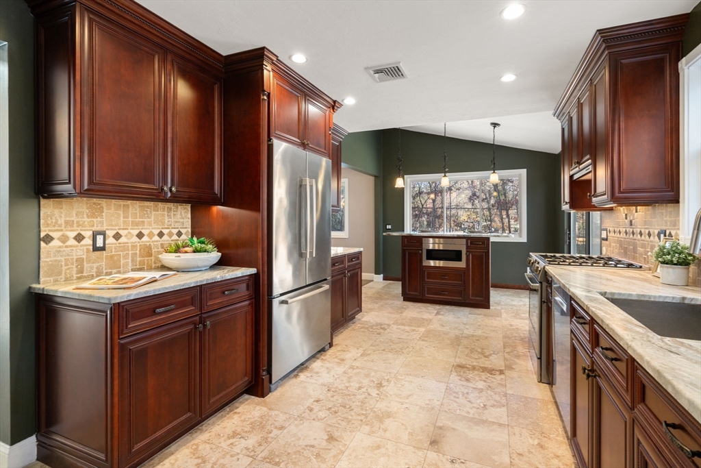 9 Mallard Drive Sharon, MA 02067 - Photo 7 of 32 a kitchen with stainless steel appliances granite countertop a refrigerator a sink a stove and wooden cabinets