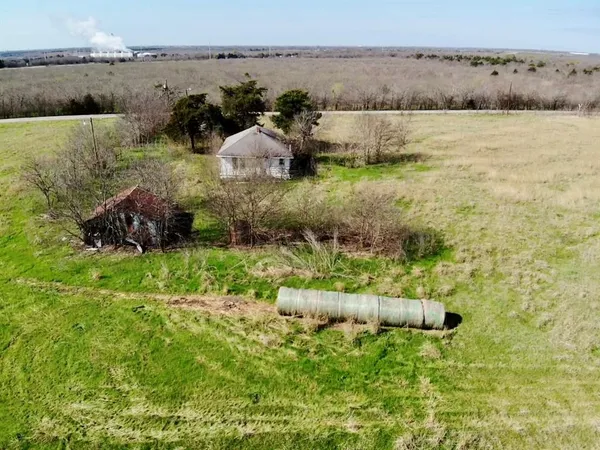 a view of a lake with lawn chairs