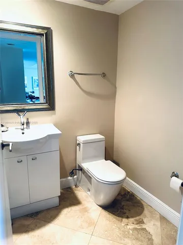 a bed sitting in a bedroom next to a lamp