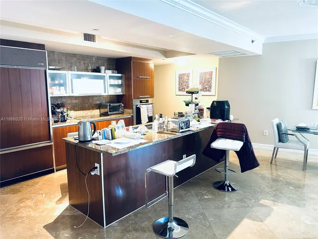 a kitchen with stainless steel appliances a sink and cabinets