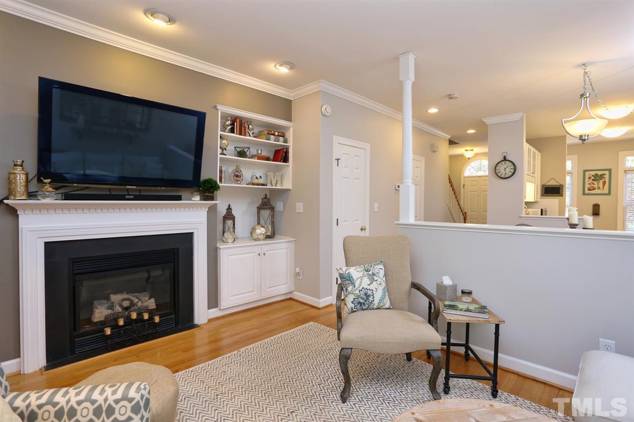 125 Fenner Lane Raleigh, NC 27603 - Photo 14 of 24 a living room with furniture a flat screen tv and a fireplace