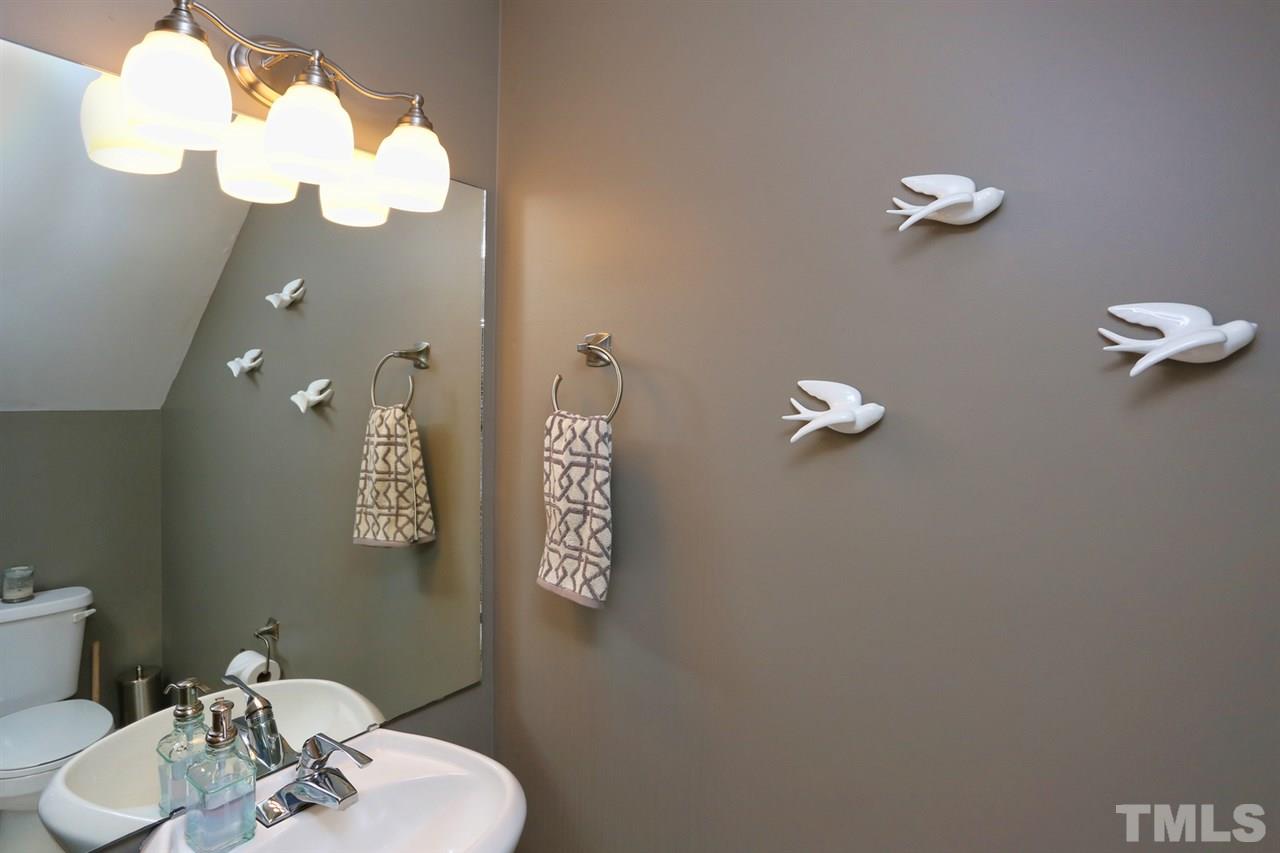 125 Fenner Lane Raleigh, NC 27603 - Photo 4 of 24 a bathroom with a sink mirror and toilet