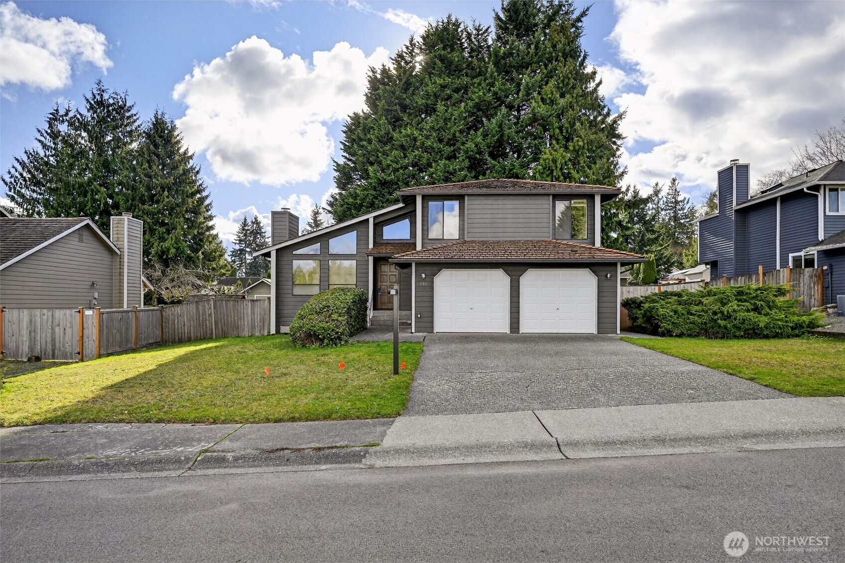 810 151st Street Southwest Lynnwood, WA 98087 - Photo 1 of 38 a front view of a house with a yard and garage
