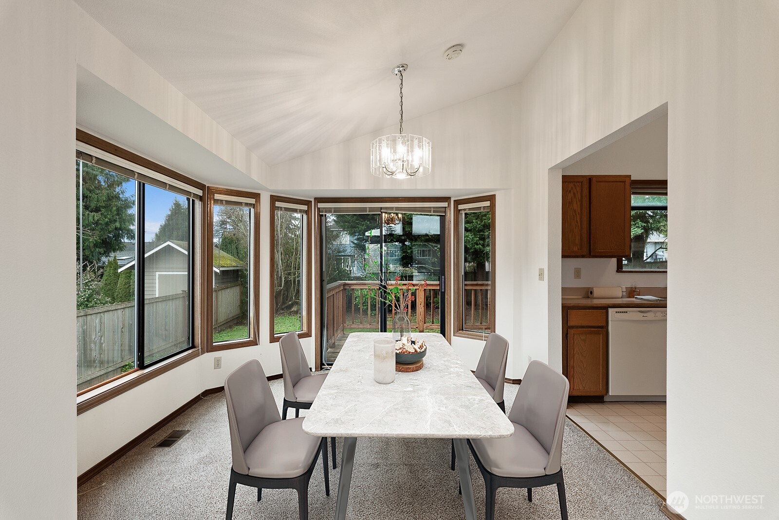 810 151st Street Southwest Lynnwood, WA 98087 - Photo 11 of 38 a view of a dining room with furniture large windows and a chandelier