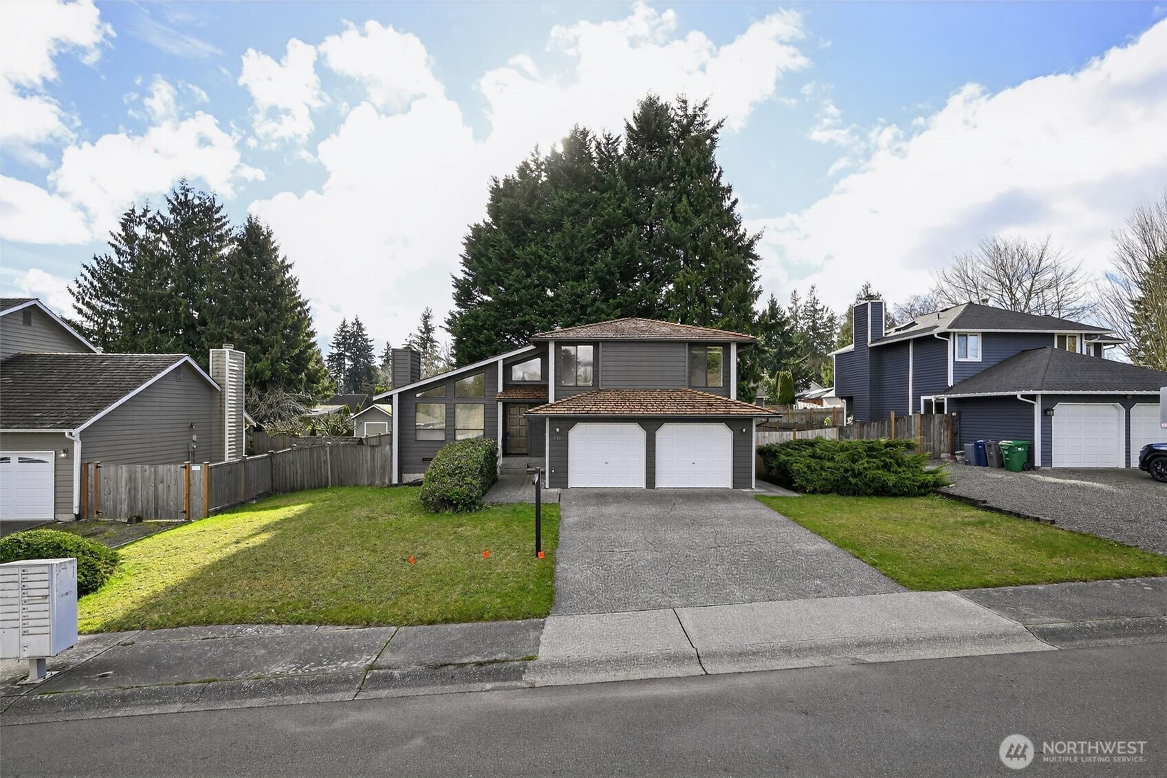 810 151st Street Southwest Lynnwood, WA 98087 - Photo 2 of 38 a front view of a house with a yard and garage