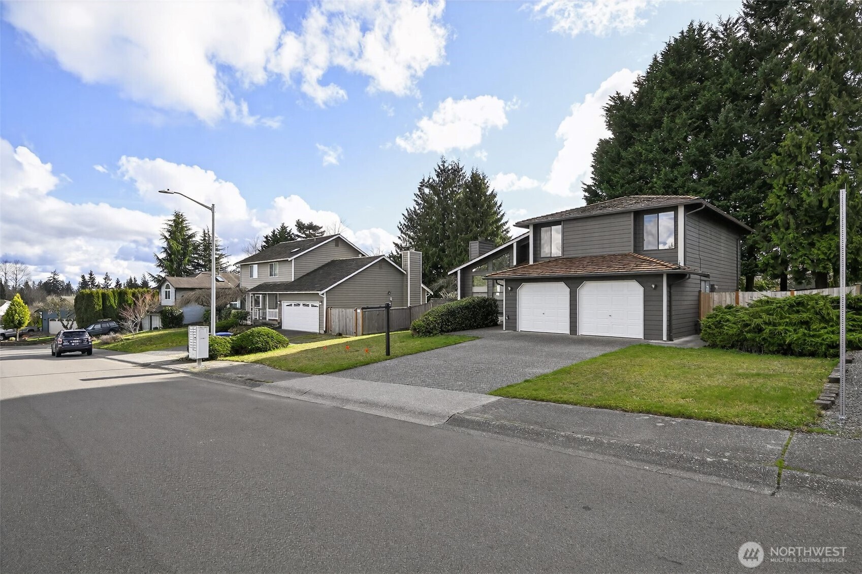 810 151st Street Southwest Lynnwood, WA 98087 - Photo 3 of 38 a front view of a house with a yard and garage
