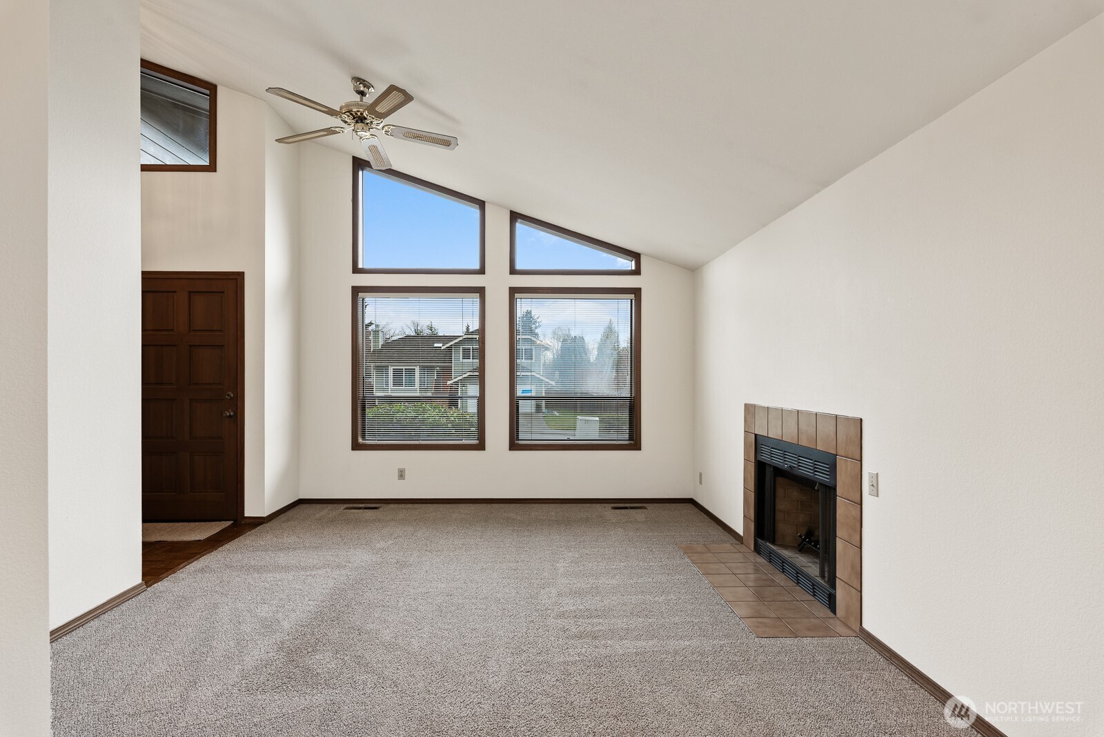 810 151st Street Southwest Lynnwood, WA 98087 - Photo 6 of 38 an empty room with windows fireplace and fans