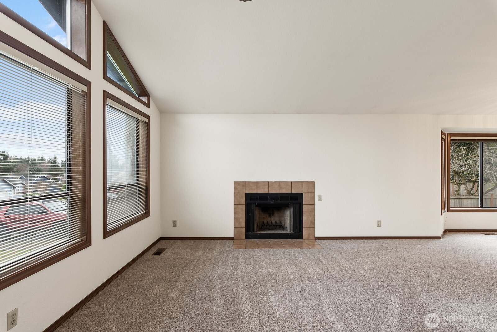 810 151st Street Southwest Lynnwood, WA 98087 - Photo 8 of 38 a view of an empty room with a fireplace and a window
