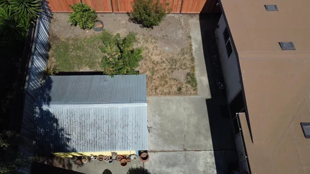 a bedroom with a bed a mirror and a window