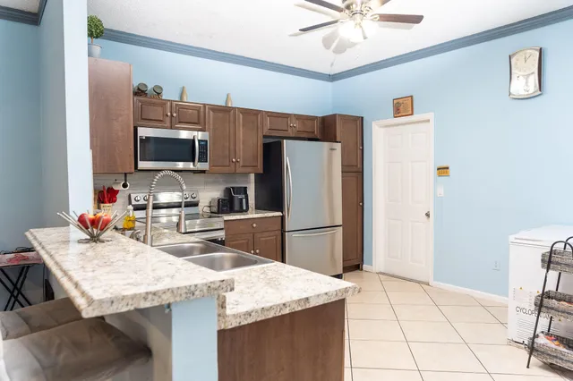 a bathroom with a sink a toilet and shower curtain