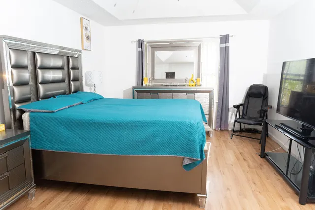 a bedroom with a bed and a dresser