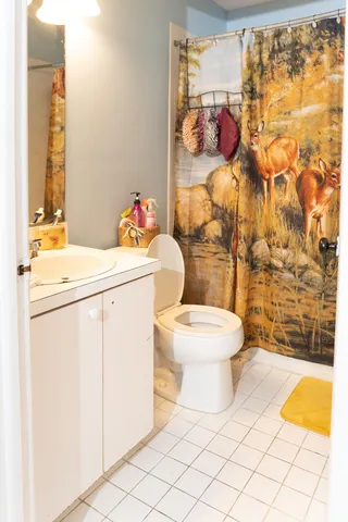 a bathroom with a toilet and a shower