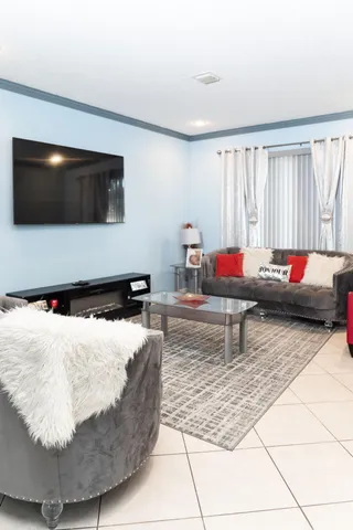 a bed sitting in a bedroom and kitchen chandelier