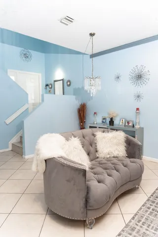 a living room with a bed and a book shelf