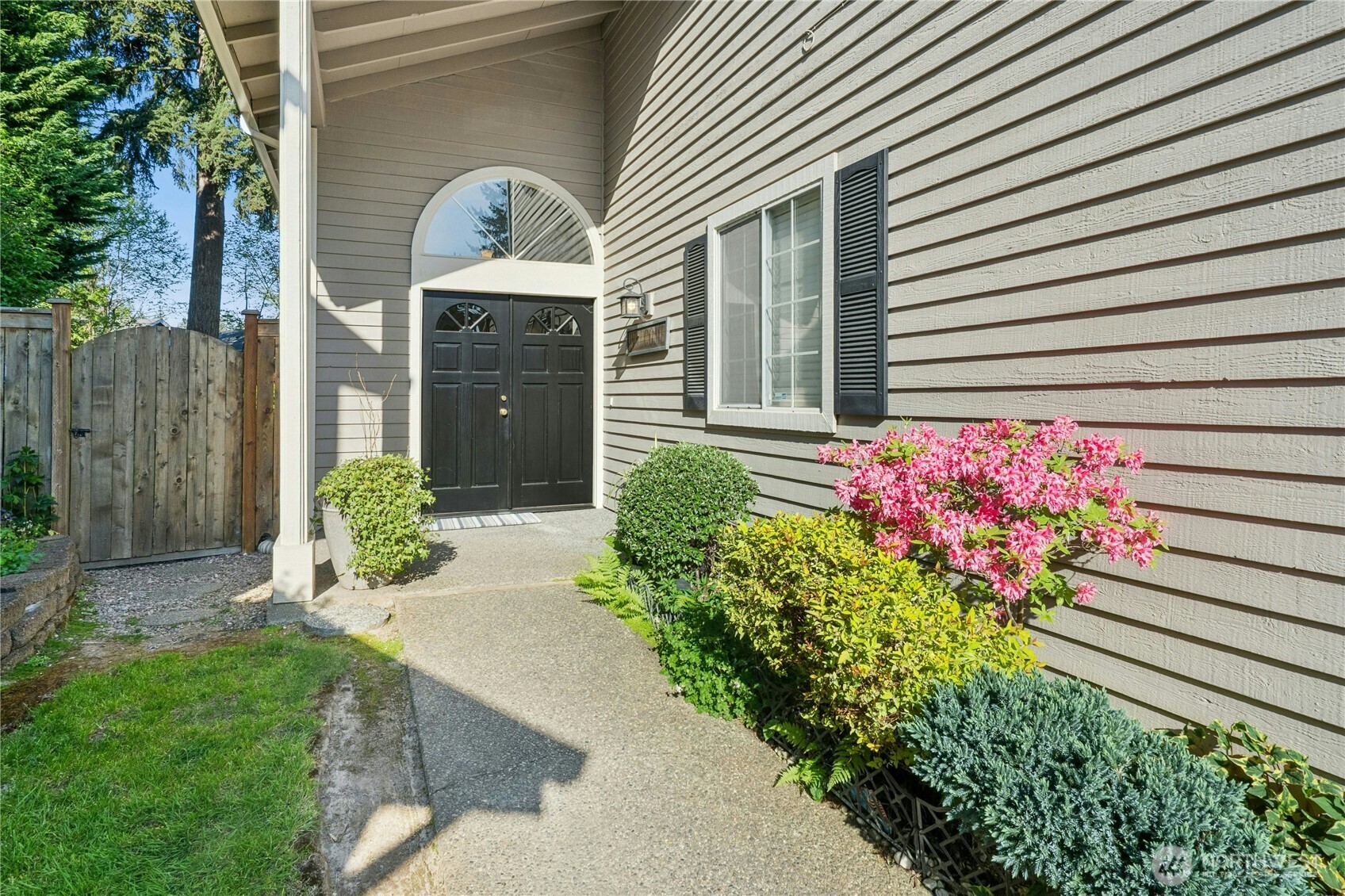12818 Northeast 203rd Place Bothell, WA 98011 - Photo 2 of 36 a front view of a house with a garden