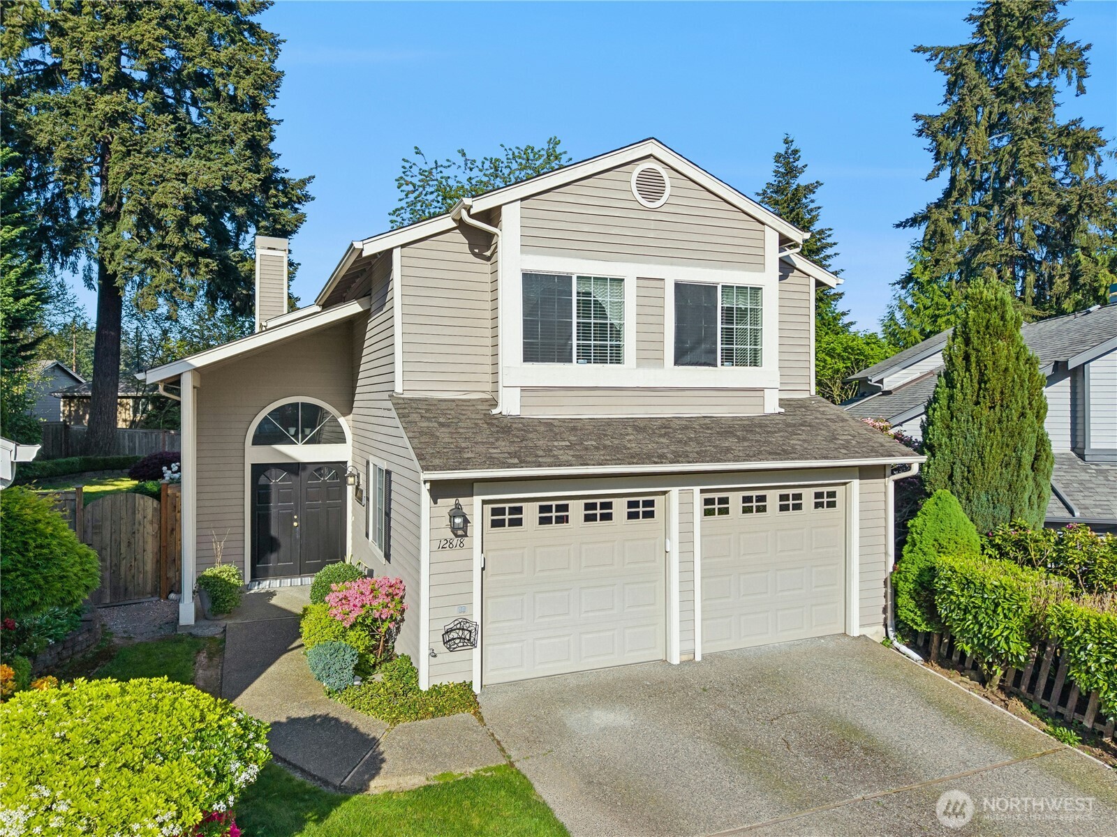 12818 Northeast 203rd Place Bothell, WA 98011 - Photo 32 of 36 a front view of a house with a garden and plants