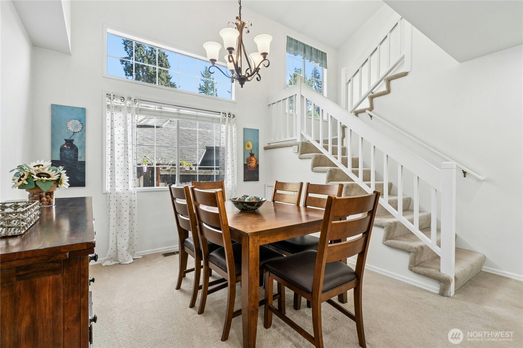 12818 Northeast 203rd Place Bothell, WA 98011 - Photo 7 of 36 a view of a dining room with furniture and a chandelier