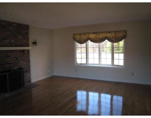 5 Ridge Road Hampden, MA 01036 - Photo 20 of 27 a view of an empty room with wooden floor and a fireplace