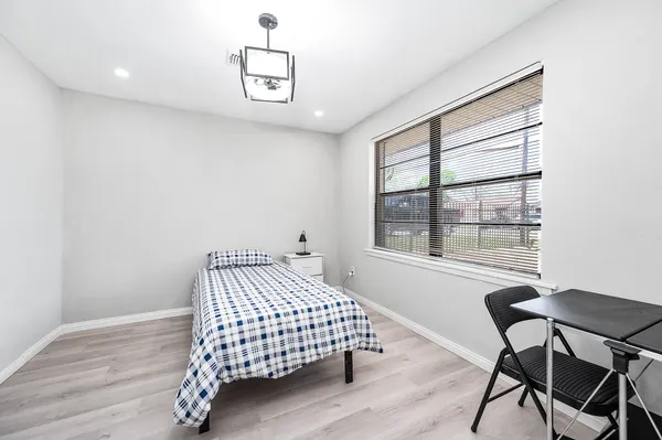 a bedroom with a bed and a window