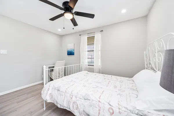 a bedroom with a bed and a chandelier