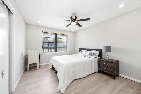 a bedroom with a bed and a window