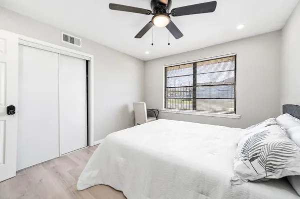 a bedroom with a large bed and a window