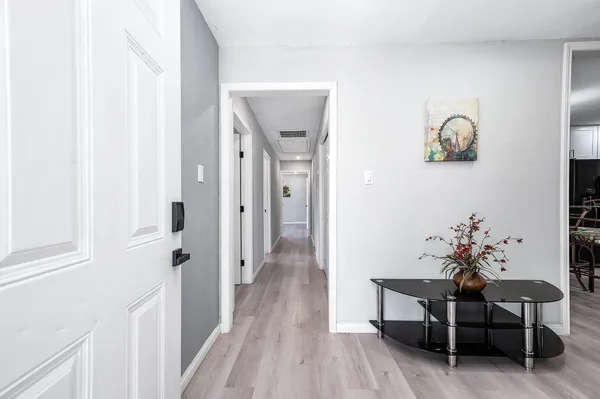 a view of a hallway and wooden floor