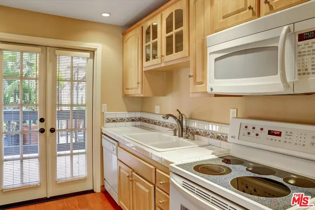 a kitchen with a stove a sink and a microwave