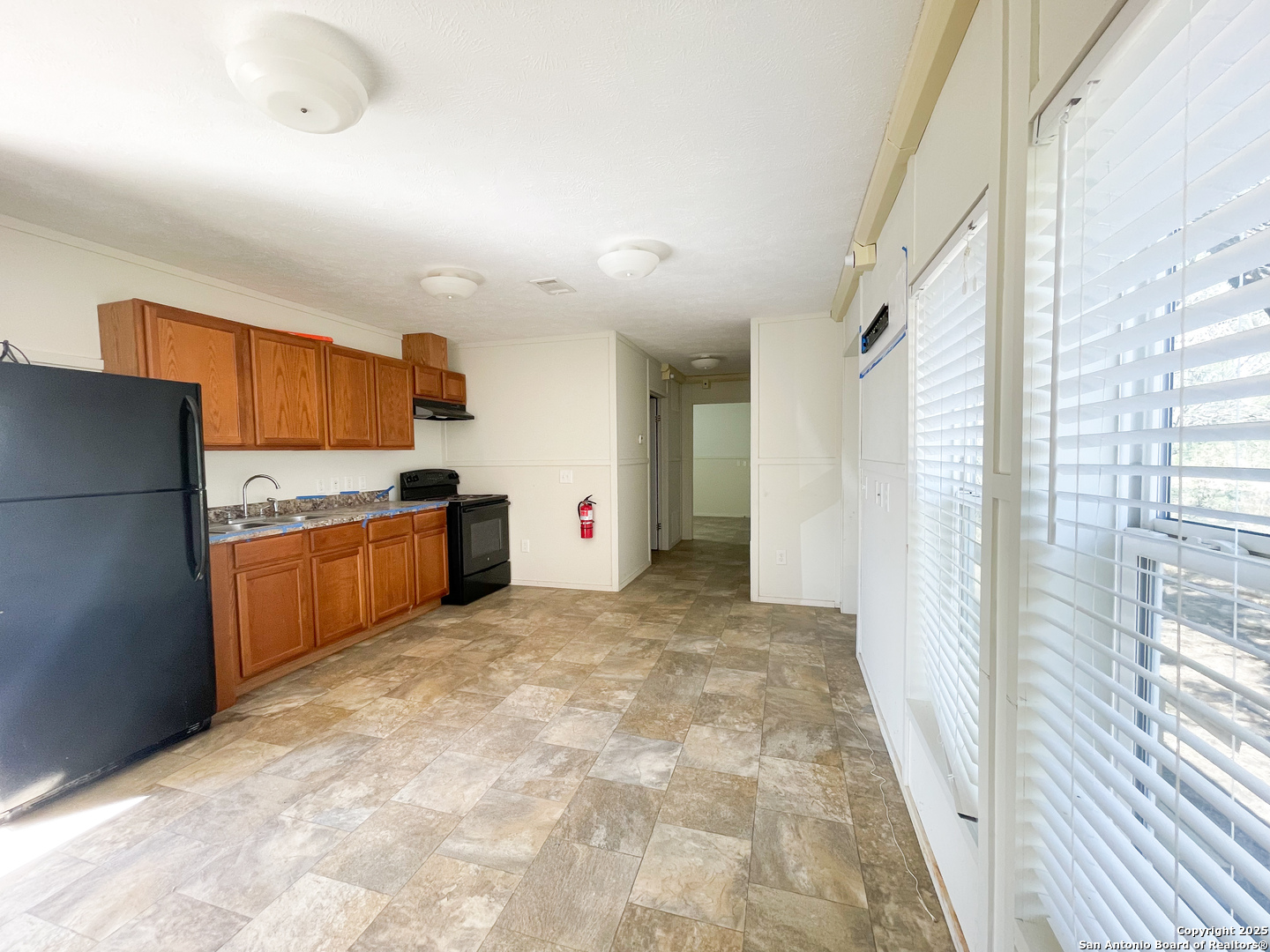 18234 Benton City Road Von Ormy, TX 78073 - Photo 12 of 25 a view of kitchen with stainless steel appliances granite countertop a refrigerator and a sink