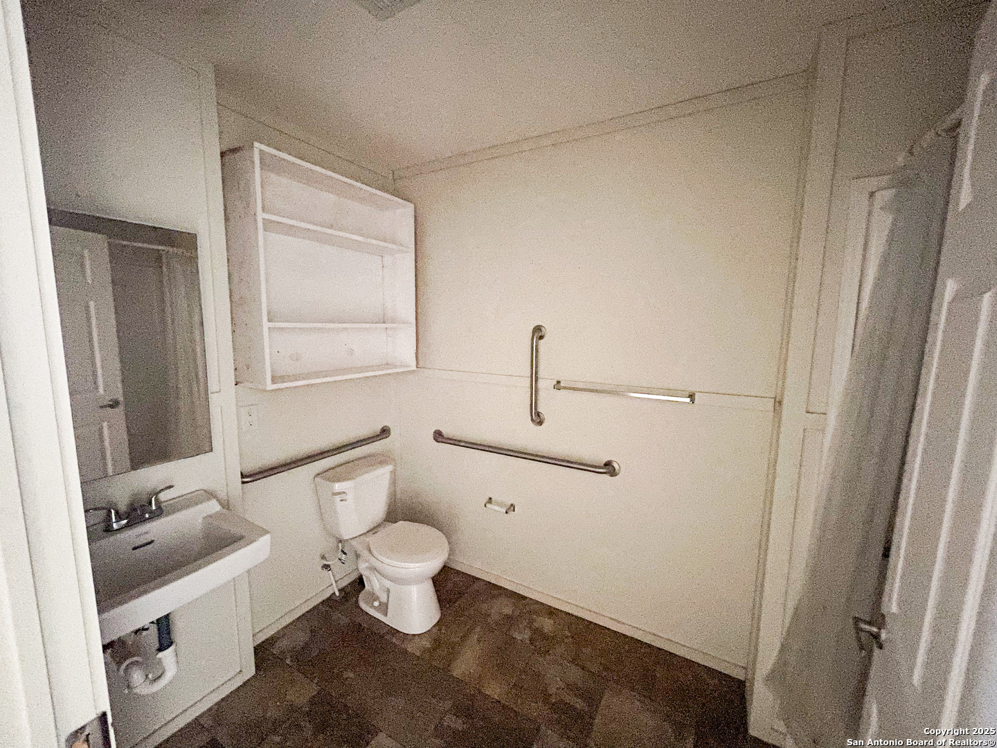 18234 Benton City Road Von Ormy, TX 78073 - Photo 13 of 25 a bathroom with a toilet a sink and a mirror