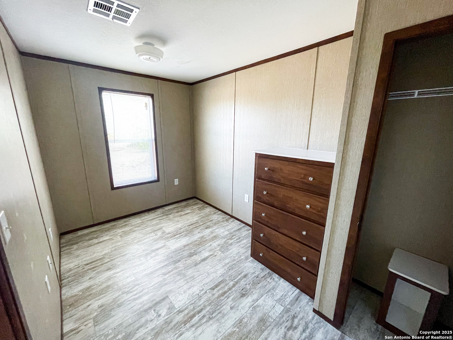 18234 Benton City Road Von Ormy, TX 78073 - Photo 15 of 25 a room with a bed and a mirror