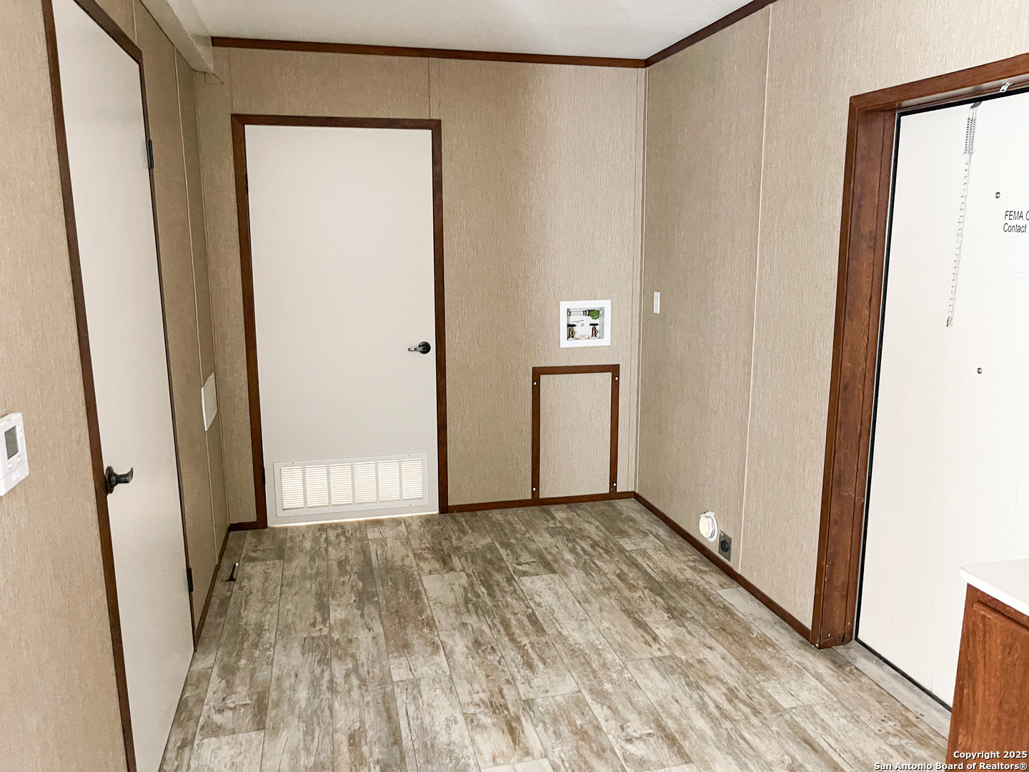 18234 Benton City Road Von Ormy, TX 78073 - Photo 19 of 25 an empty room with wooden door