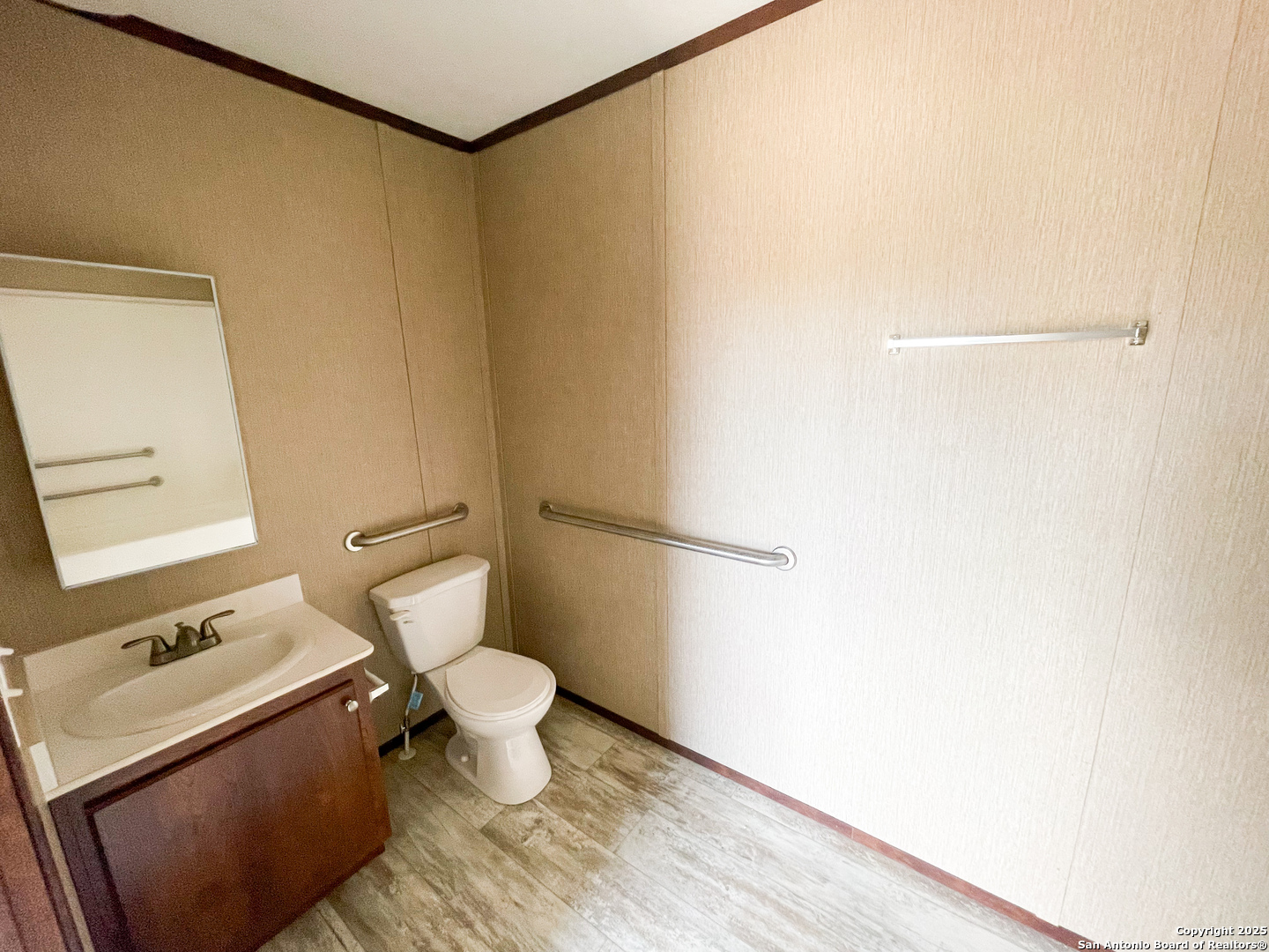 18234 Benton City Road Von Ormy, TX 78073 - Photo 20 of 25 a white toilet sitting next to a bathroom sink