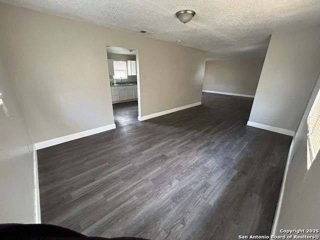 18234 Benton City Road Von Ormy, TX 78073 - Photo 2 of 25 an empty room with wooden floor and closet