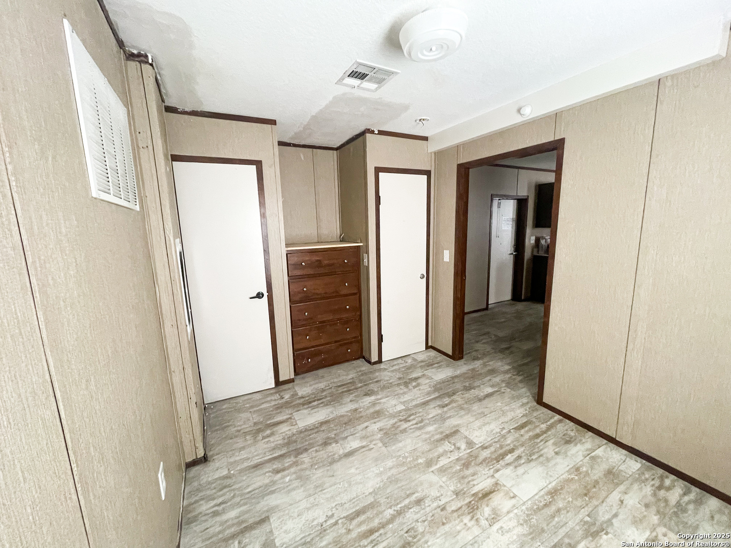 18234 Benton City Road Von Ormy, TX 78073 - Photo 22 of 25 a view of a hallway with wooden shelves
