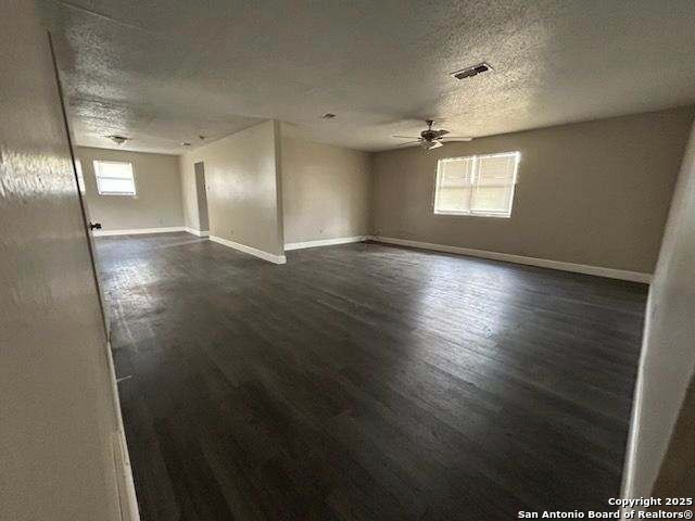 18234 Benton City Road Von Ormy, TX 78073 - Photo 3 of 25 an empty room with wooden floor and windows