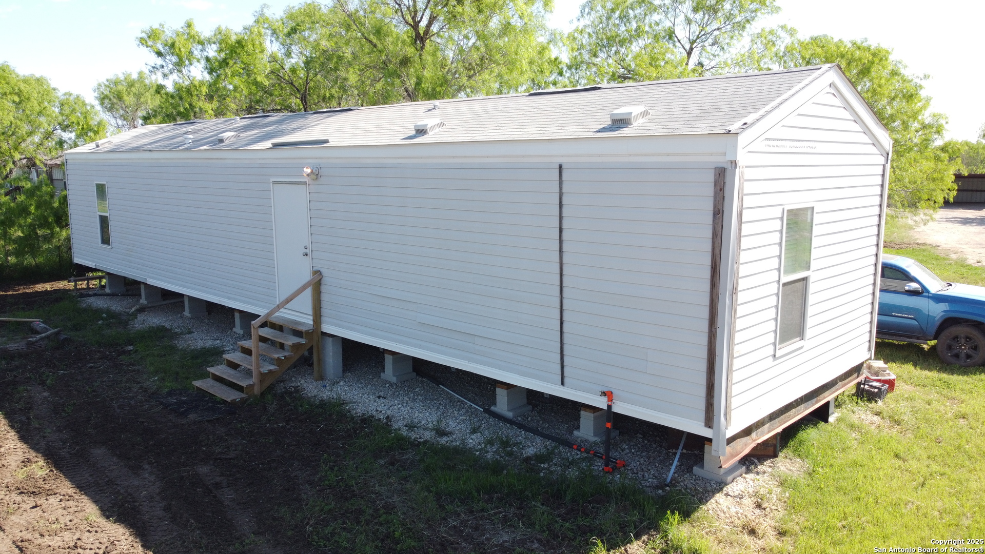 18234 Benton City Road Von Ormy, TX 78073 - Photo 5 of 25 a view of a small house with a yard