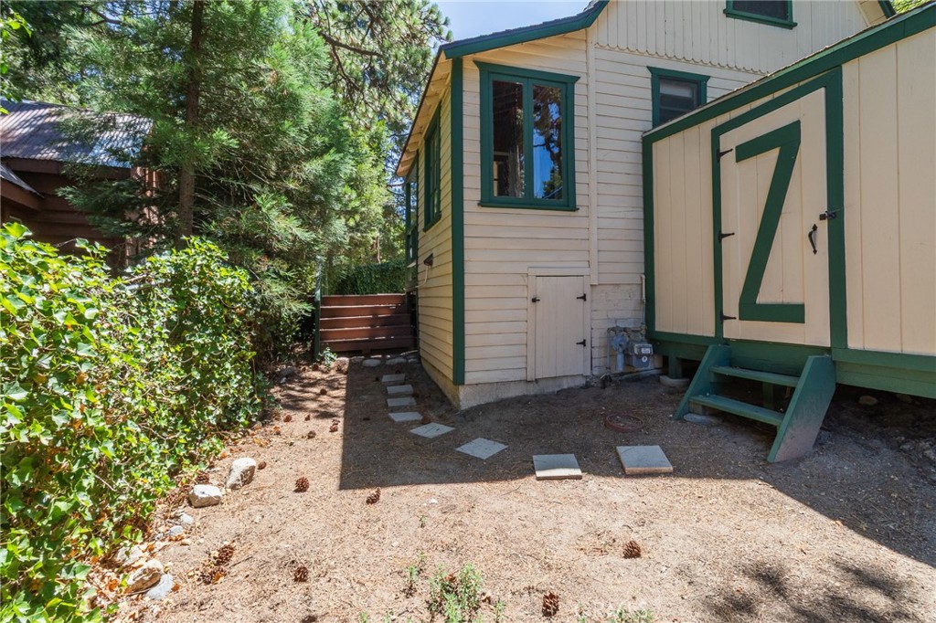 26370 Alpine Lane Twin Peaks, CA 92391 - Photo 6 of 37 a view of a backyard with table and chairs and potted plants