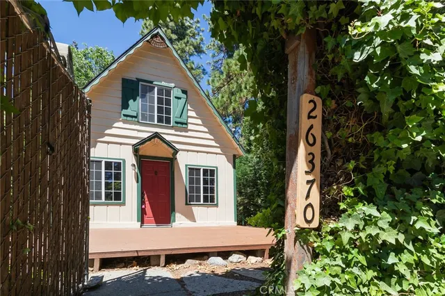a view of house with tub and trees in the background