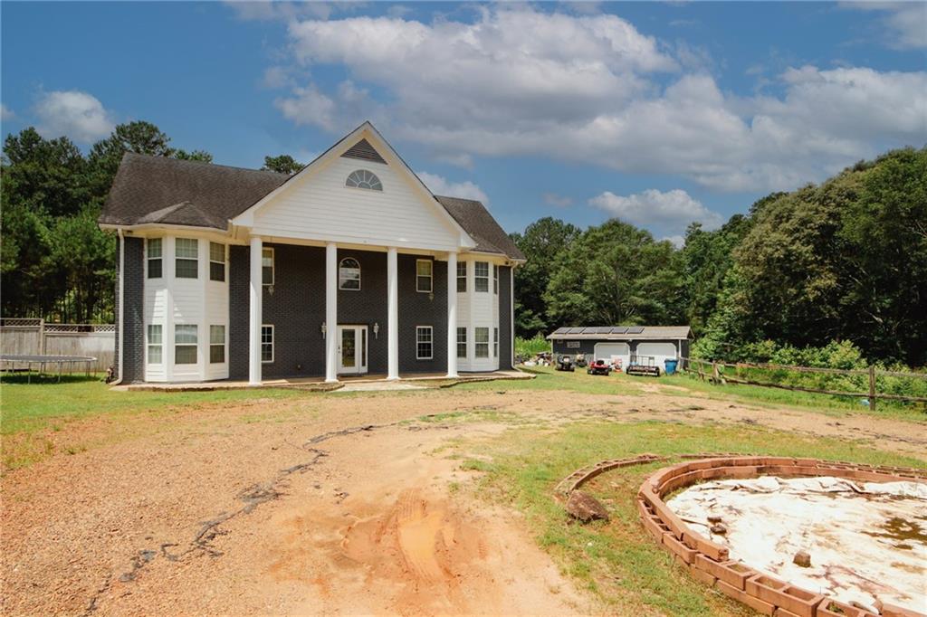 a view of a house with pool and chairs