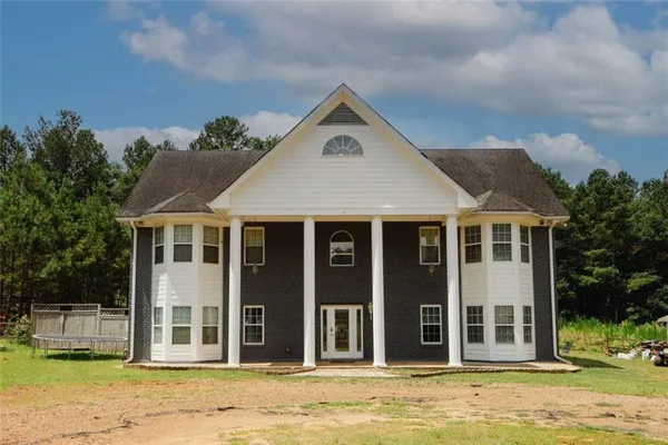 a front view of a house with a yard