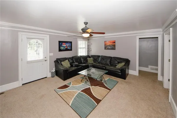 a spacious bedroom with a bed and a flat screen tv