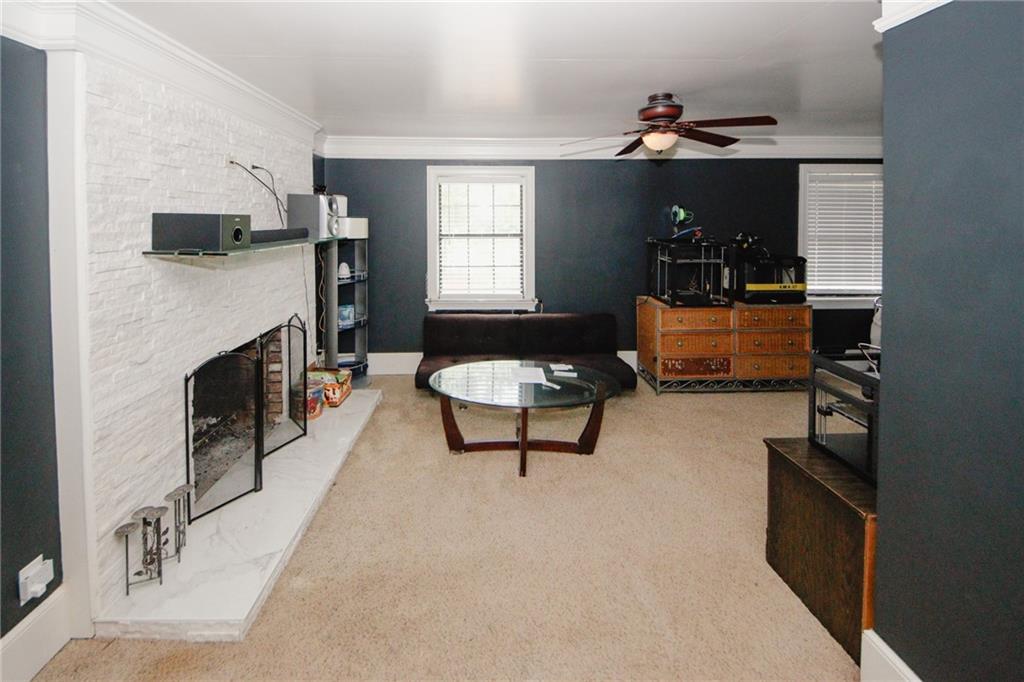 1120 Carl-Bethlehem Road Winder, GA 30680 - Photo 29 of 57 a living room with furniture and a fireplace