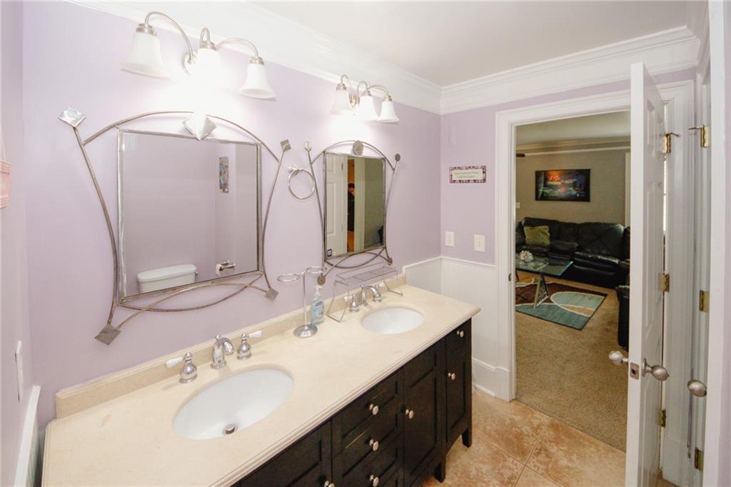 1120 Carl-Bethlehem Road Winder, GA 30680 - Photo 39 of 57 a bathroom with a double vanity sink a mirror and shower