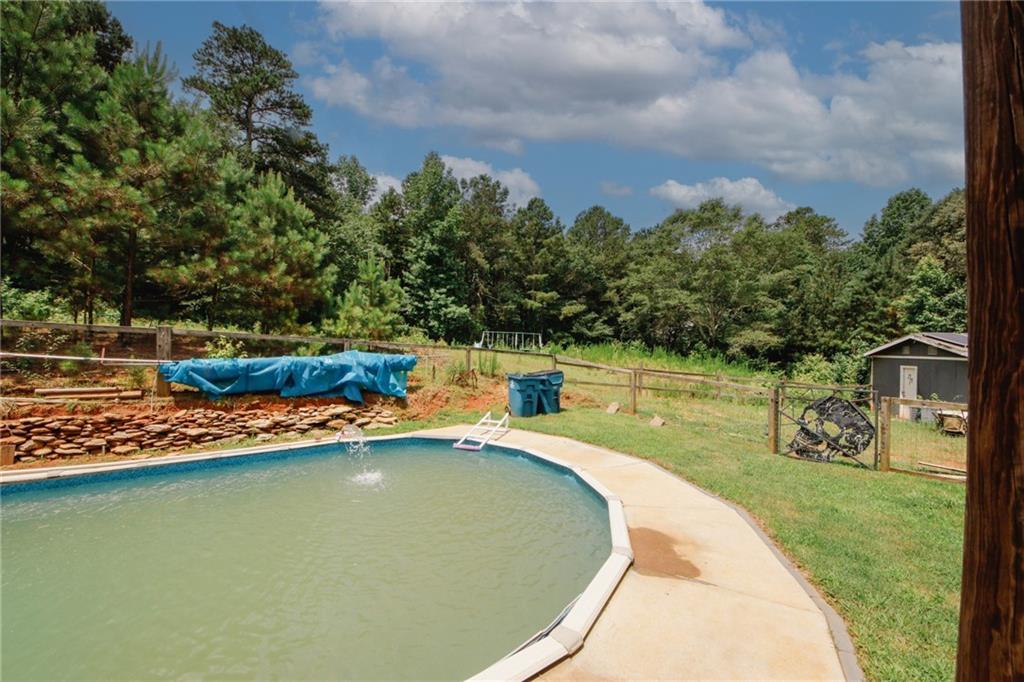 1120 Carl-Bethlehem Road Winder, GA 30680 - Photo 53 of 57 a view of a swimming pool with a yard