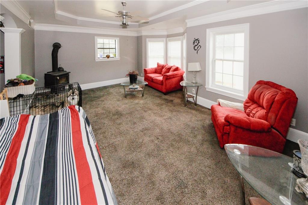 1120 Carl-Bethlehem Road Winder, GA 30680 - Photo 8 of 57 a living room with furniture a flat screen tv and a large window