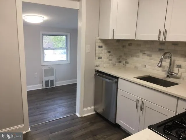 a kitchen with a sink cabinets and a window