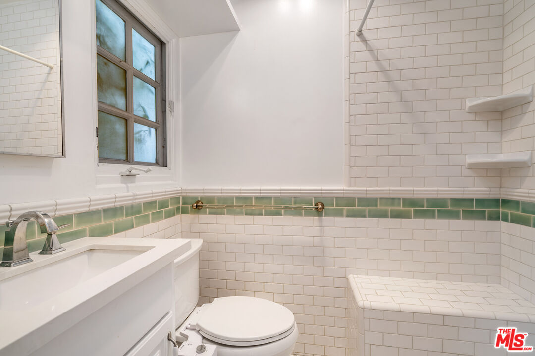 2125 Rockledge Road Los Angeles, CA 90068 - Photo 13 of 21 a bathroom with a sink a toilet and mirror