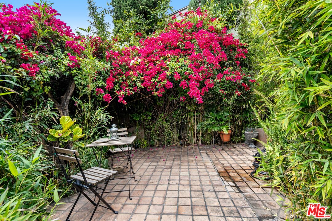 2125 Rockledge Road Los Angeles, CA 90068 - Photo 16 of 21 a backyard of a house with table and chairs and wooden fence