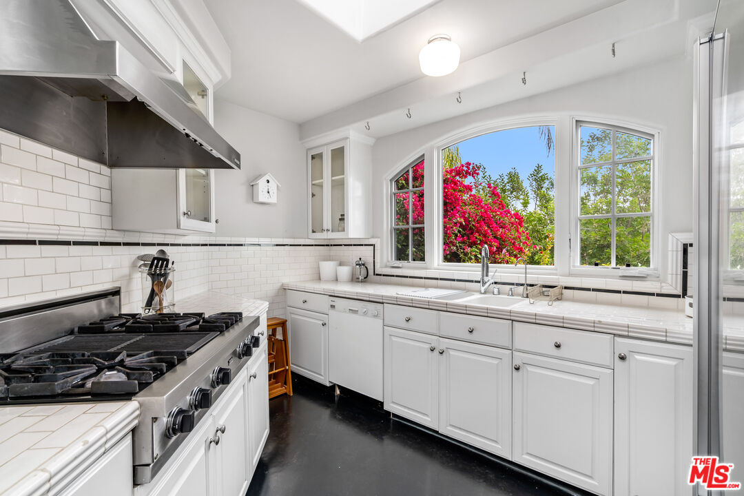 2125 Rockledge Road Los Angeles, CA 90068 - Photo 5 of 21 a kitchen with stainless steel appliances a stove sink and cabinets